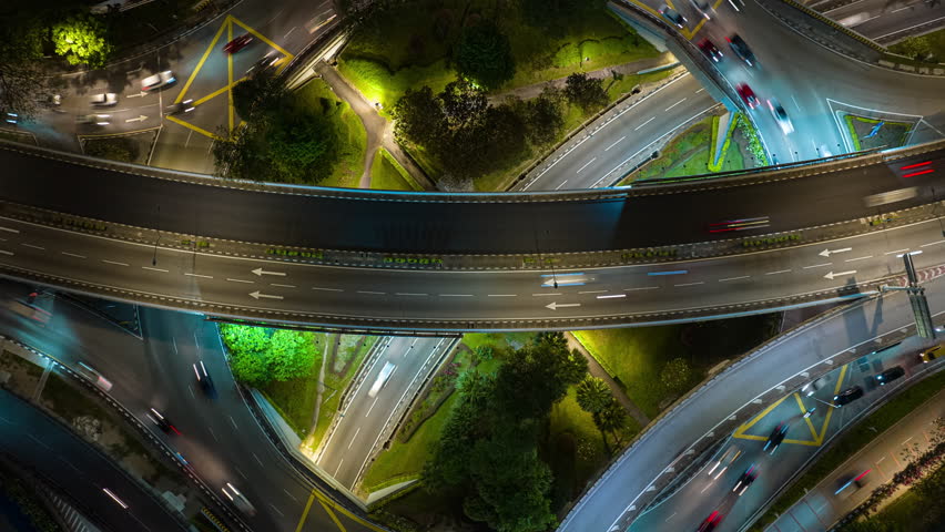 night time illumination flight over kuala lumpur city traffic interchange circle road aerial topdown panorama 4k timelapse malaysia