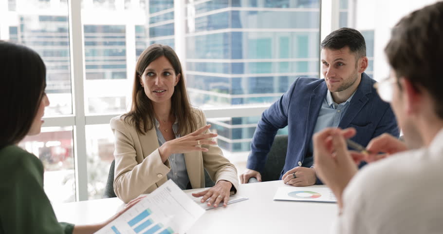 Business partners gather in meeting room, lead talk, share insights and business vision, take part in seminar or negotiations with shareholders, planning project, discussing risk management strategies