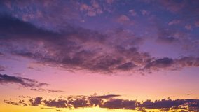 Sunset time lapse with sun and clouds on blue and orange dramatic sky with sun rays. Night sunset Sky timelapse. Moving clouds at sunset. Evening Clouds. Dusk sunset sky time lapse. Dramatic sky. - Powered by Shutterstock - Get 15% off with code: PIKWIZARD15