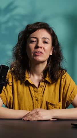 Vertical video Influencer feeling angry, sharing concerning story during social media video, talking to fans. Frustrated content creator talks with viewers, having mental breakdown in front of