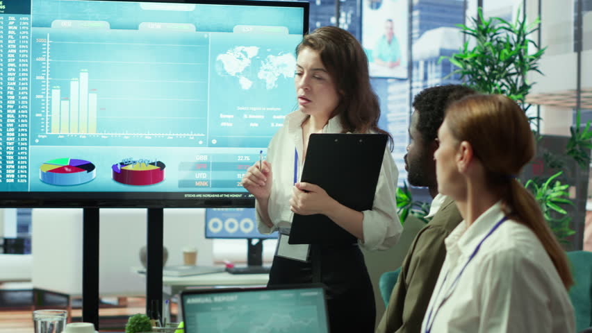 Corporate associates looking into project details and timetables in conference room, establishing budget and operations to accomplish objectives in a competitive business environment. Camera A.