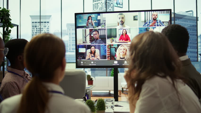 Company employees attending a meeting via videocall with investors, discussing about the future of the enterprise. Advisory board and workers examining infographics data for management. Camera B.