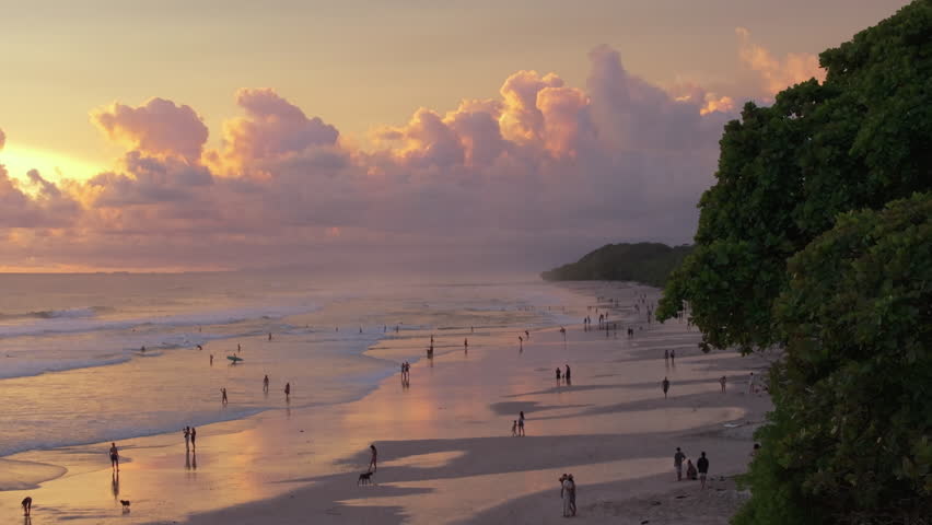 Discover Playa Santa Teresa in Puntarenas, Costa Rica. This aerial view showcases its golden sands and sunset, making it an ideal coastal paradise for tourists, surfers, and nature enthusiasts