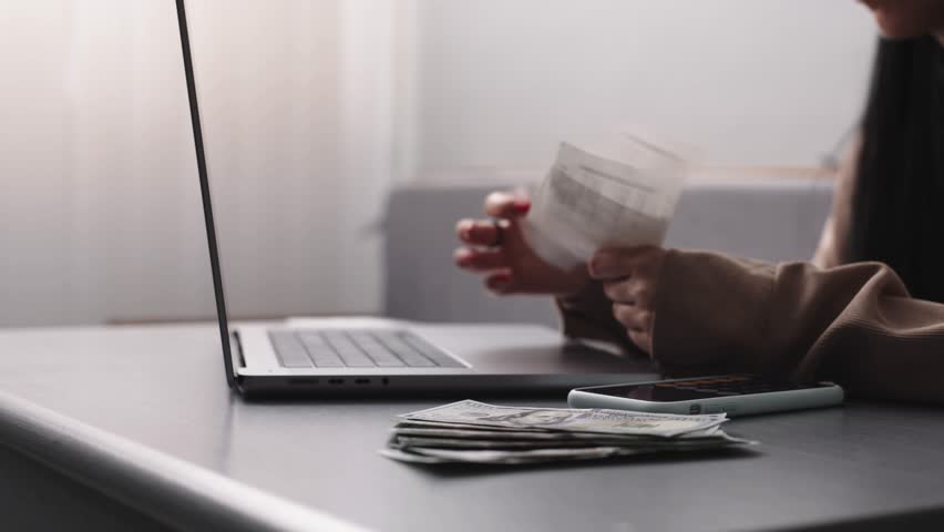 Woman Managing Personal Finances at Desk, Using Laptop to Calculate Expenses and Pay Bills Online, Performing Household Financial Analysis and Budget Management for Effective Expense Tracking