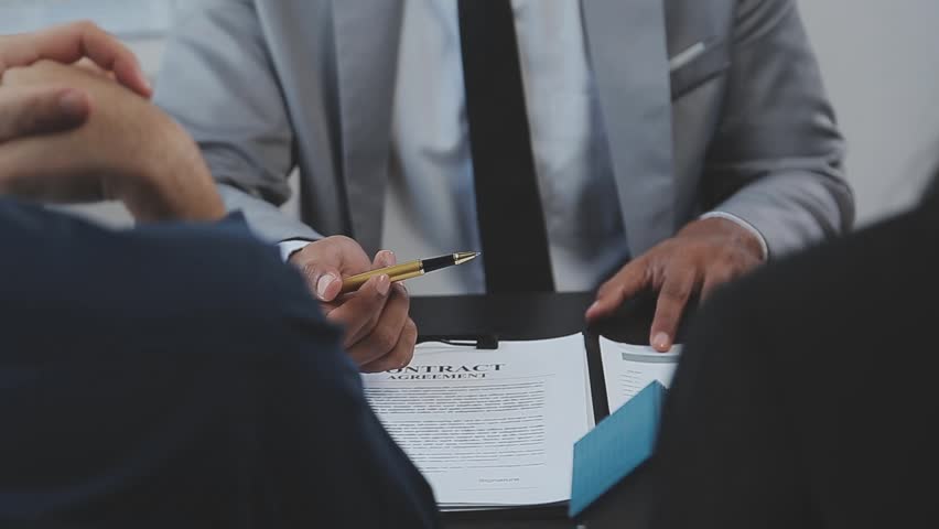 Home Buyers Negotiating With Real Estate Agents in an Office Setting, Exploring Property Purchase or Rental Opportunities and Discussing Financial Arrangements