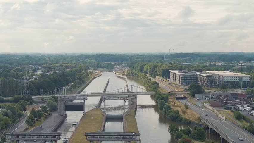 Dolly zoom. Ghent, Belgium. Ringvaart in Ghent - water channel. Sluis Merebeke - landmark, gateway to the Ringvaart Ghent canal in the town of Merebeke, Aerial View