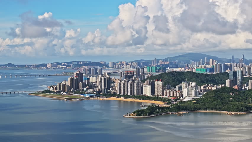 Beautiful coastline and city skyline with modern building scenery in Zhuhai. Aerial view of coastal city buildings in China.