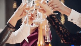Happy festive group of friends drinking alcohol celebrating Christmas New Year waving sparklers. Close up hands cheers champagne clinking glasses. Smiling multiethnic people at Christmas eve night. - Powered by Shutterstock - Get 15% off with code: PIKWIZARD15