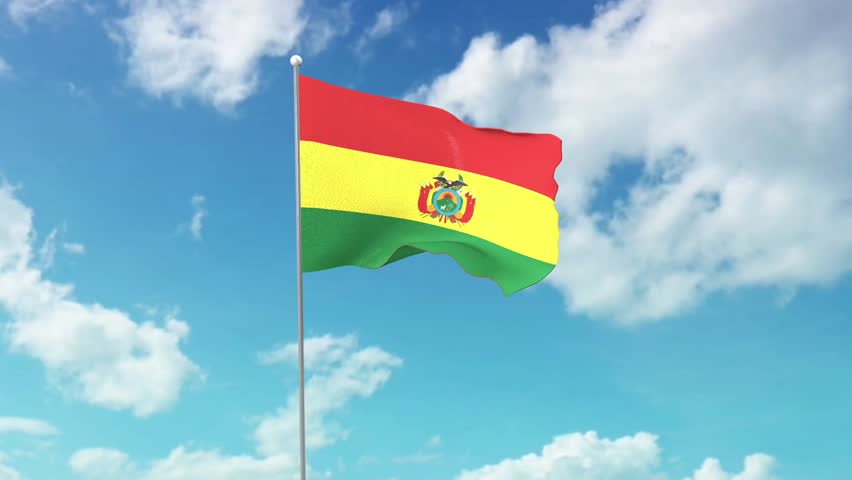 The national flag of Bolivia, fluttering in the blue sky.