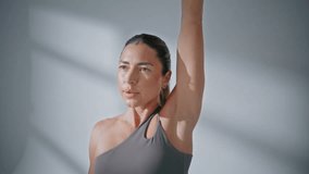 Strong lady doing dumbbells workout in gym closeup. Athletic trainer girl looking camera practicing exercises with weights in turn portrait. Fitness motivated woman training muscles. Sport concept  - Powered by Shutterstock - Get 15% off with code: PIKWIZARD15