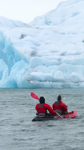  view of people on kayaks sailing in the glacial lagoon 