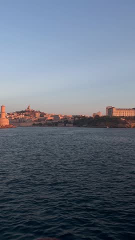 Marseille with a view of the Old Port and Notre Dame de la Garde with the colors of the sunset.