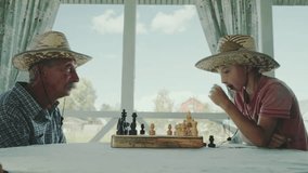 grandfather and grandson playing chess in nature - Powered by Shutterstock - Get 15% off with code: PIKWIZARD15