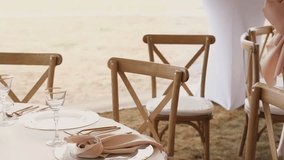 Event planner in pink sweater carefully places folded napkin on plate in slow motion - Powered by Shutterstock - Get 15% off with code: PIKWIZARD15