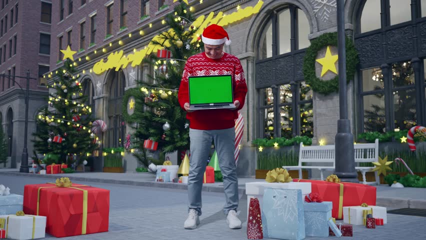 Full Body Of Asian Man In Christmas Suit With A Smile Showing Green Screen Laptop While Standing In Christmas Night - Powered by Shutterstock - Get 15% off with code: PIKWIZARD15