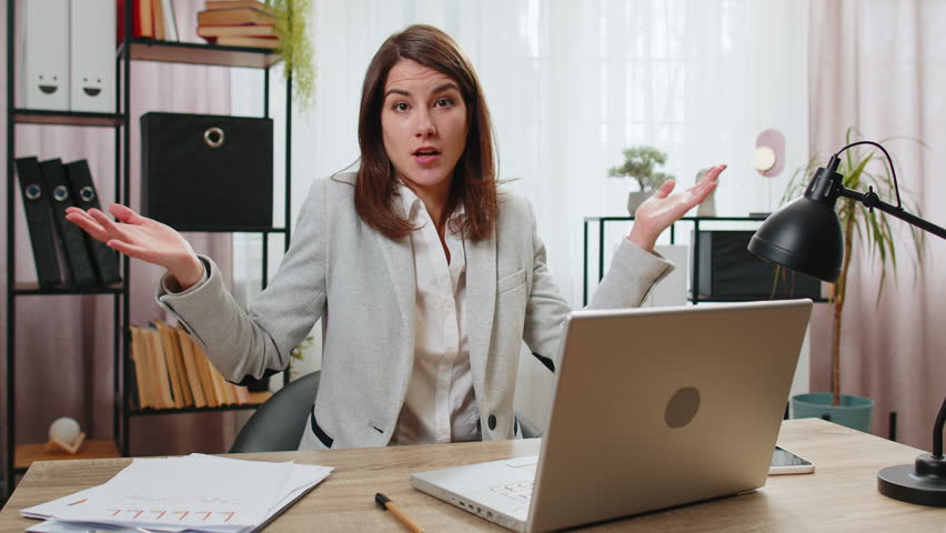 I don't know what to say. Confused businesswoman working on laptop at home office desk. Freelancer feeling embarrassed about ambiguous question having doubts, no answer idea, being clueless, uncertain