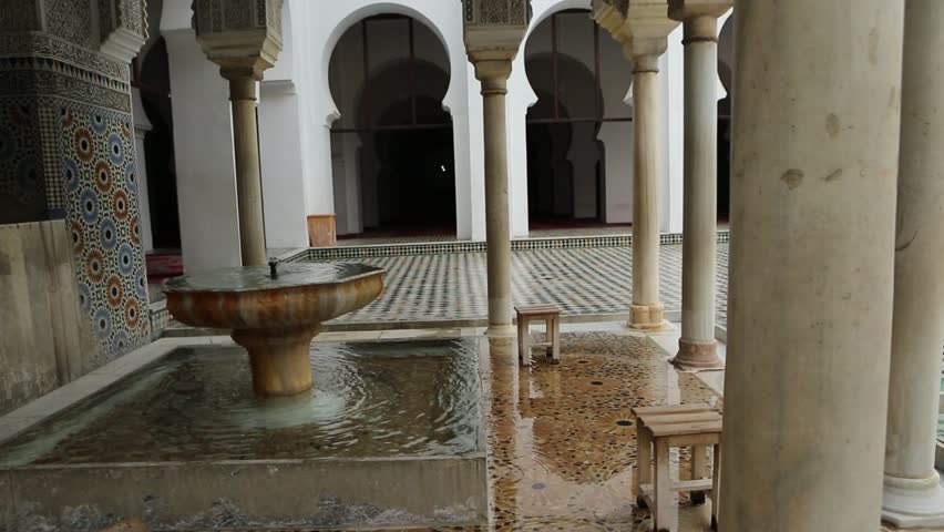 A mosque in Morocco with a water basin and seats 