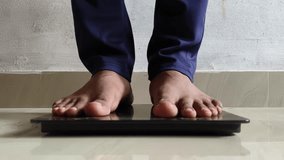 Young adult person feet standing on digital weighing scale machine to measure, check body weight or fat. Dieting, obesity, overweight, underweight, fitness, weight loss and healthy lifestyle concept. - Powered by Shutterstock - Get 15% off with code: PIKWIZARD15
