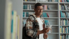 African American man guy user mobile phone smartphone cellphone network student study educational bookcase bookstore library internet wifi online university archive high school browser literature male - Powered by Shutterstock - Get 15% off with code: PIKWIZARD15
