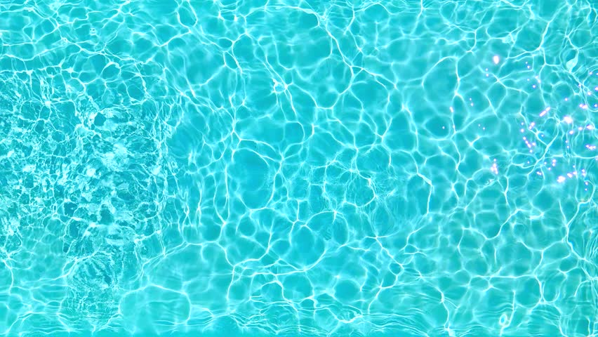 Blue water in the swimming pool with light reflections. Slow motion