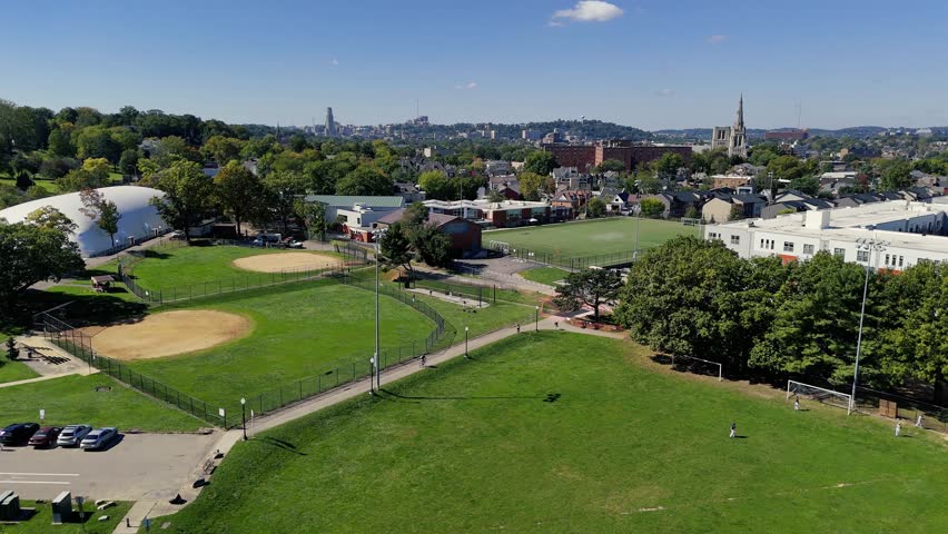 A low angle aerial urban view of sports playing fields in Pittsburgh