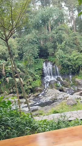 Waterfall with forest stream and green moss.