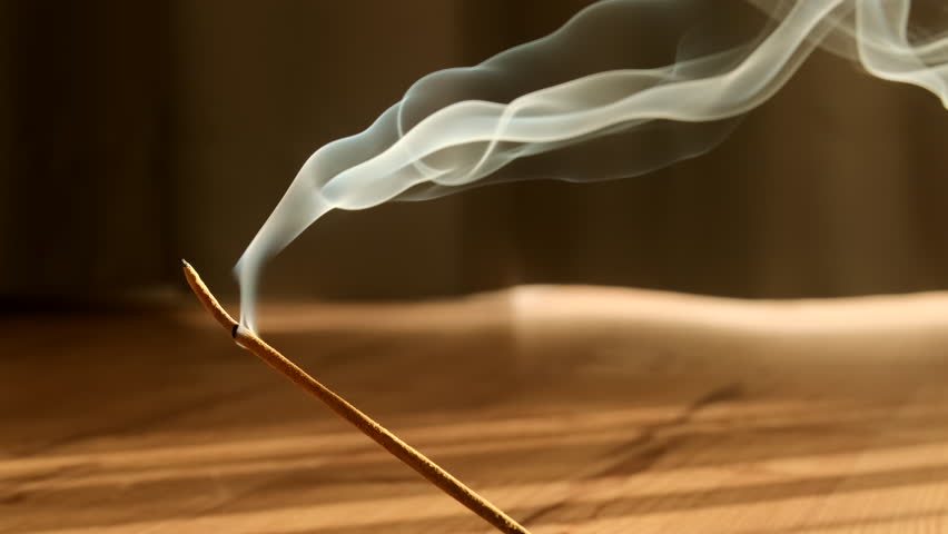 Burning aromatic incense smoky stick for meditation and relaxing. Aromatherapy smoke for yoga or SPA concept.