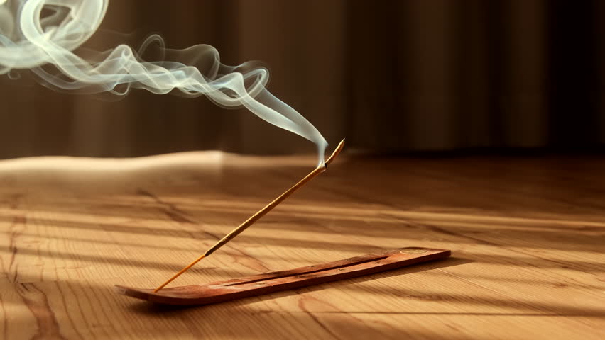 Burning aromatic incense smoky stick for meditation and relaxing. Aromatherapy smoke for yoga or SPA concept.