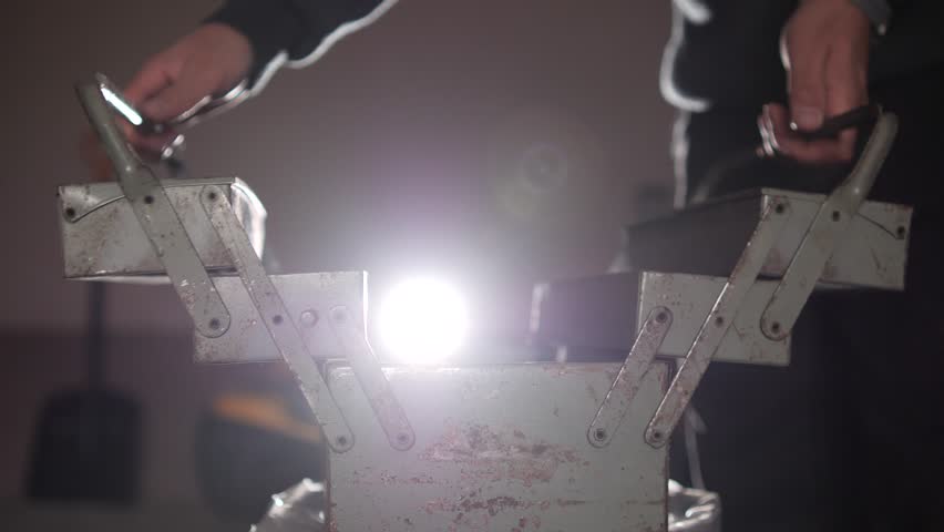 close-up Male worker opening old vintage metal toolbox