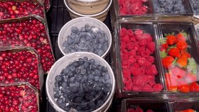 buying fruits and  berries ( raspberries, blueberries, strawberries, gooseberries)at the market - Powered by Shutterstock - Get 15% off with code: PIKWIZARD15