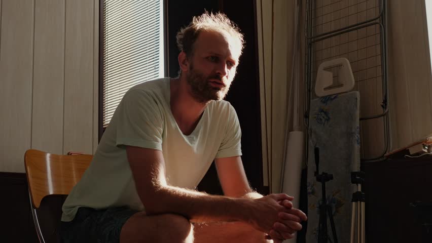 A man, struggling with long-term alcohol addiction, takes a courageous step and attends an Alcoholics Anonymous meeting, seeking support and a path to recovery.