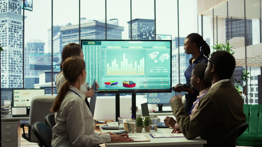 PR team presenting infographics and digital marketing insights for growth, showcasing the impact of recent campaigns and outlining plans for future development initiatives in workspace. Camera B.