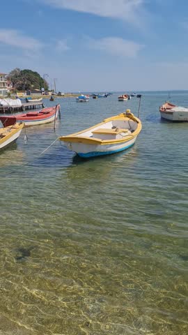 Boats in clear waters at the Araruama Lagoon in Praia da Pitória, São Pedro da Aldeia, with a tropical backdrop. Peaceful coastal scene showcasing the natural beauty of Brazil’s vibrant shoreline.