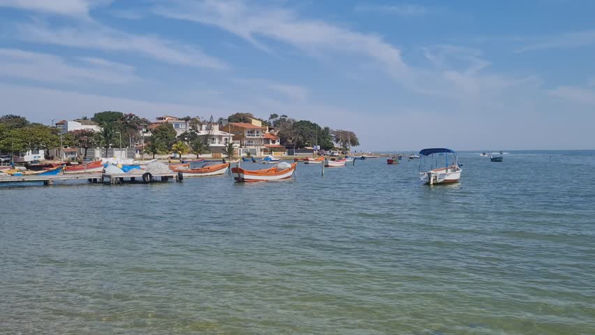 Boats in clear waters at the Araruama Lagoon in Praia da Pitória, São Pedro da Aldeia, with a tropical backdrop. Peaceful coastal scene showcasing the natural beauty of Brazil’s vibrant shoreline.