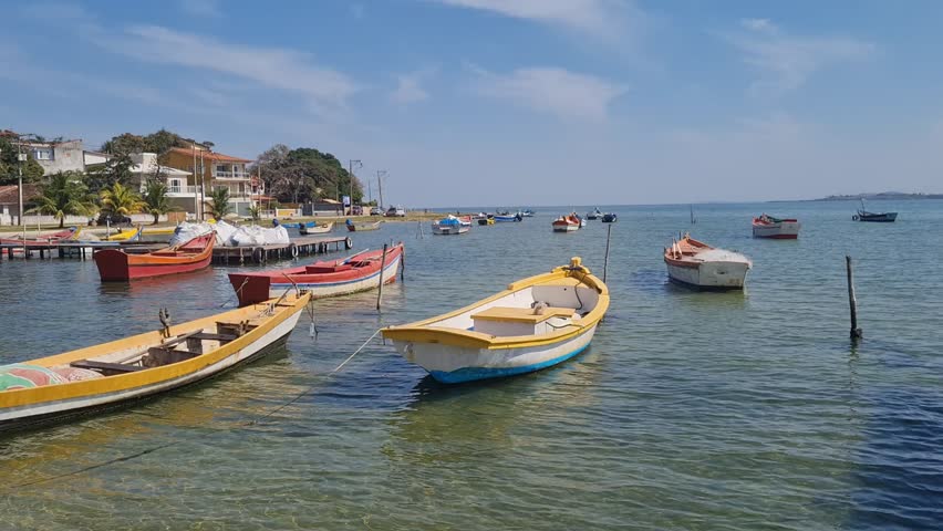 Boats in clear waters at the Araruama Lagoon in Praia da Pitória, São Pedro da Aldeia, with a tropical backdrop. Peaceful coastal scene showcasing the natural beauty of Brazil’s vibrant shoreline.