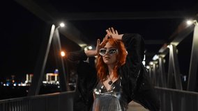 Portrait of a beautiful fiery red-haired woman on a city street at night. - Powered by Shutterstock - Get 15% off with code: PIKWIZARD15