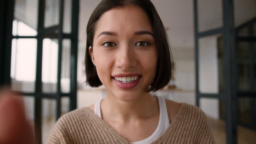 POV webcam point of view female girl addict influencer Caucasian smiling woman happy surprised read message online chatting using mobile phone touchscreen typing sms cellphone gadget screen at home