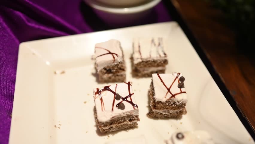 a piece of cake on a plate with a mint leaf on top