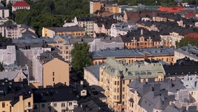 Camera moving over a downtown neighborhood in Helsinki, Finland revealing colorful buildings, green trees and streets full of cars - Powered by Shutterstock - Get 15% off with code: PIKWIZARD15