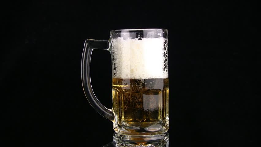 The beer from the mug, filled up to edges, is poured through edge. The foam sits