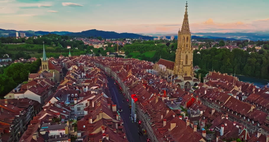 Aerial view over the city of Bern the capital city of Switzerland the historic district from above. Bern old town. The historic buildings in the city center. Wide establishing aerial golden sunset
