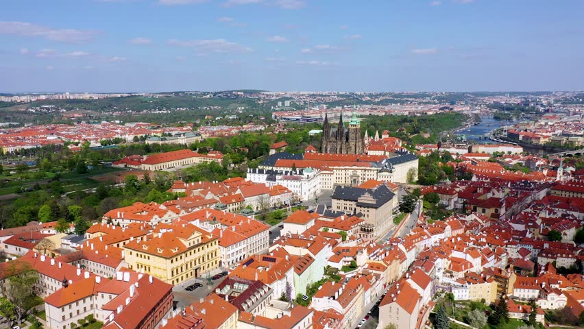View of Prague featuring vibrant rooftops on a sunny day in summer. Aerial view of Prague, Charles Bridge over Vltava river in Prague, Czechia. Old Town of Prague, Czech Republic.