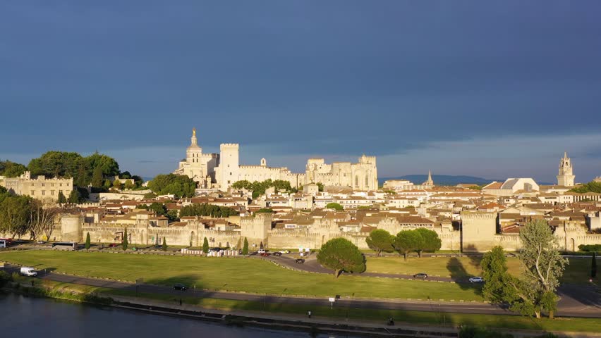 View of Avignon with Palais des Papes during sunset in Southern France. Medieval architecture along the Rhone River in Avignon, Provence, France. The Palais des Papes in Avignon, South France.