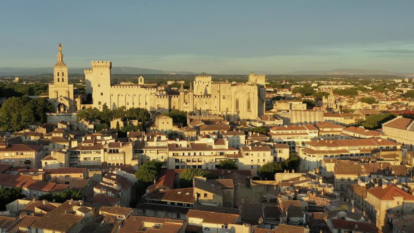 View of Avignon with Palais des Papes during sunset in Southern France. Medieval architecture along the Rhone River in Avignon, Provence, France. The Palais des Papes in Avignon, South France.