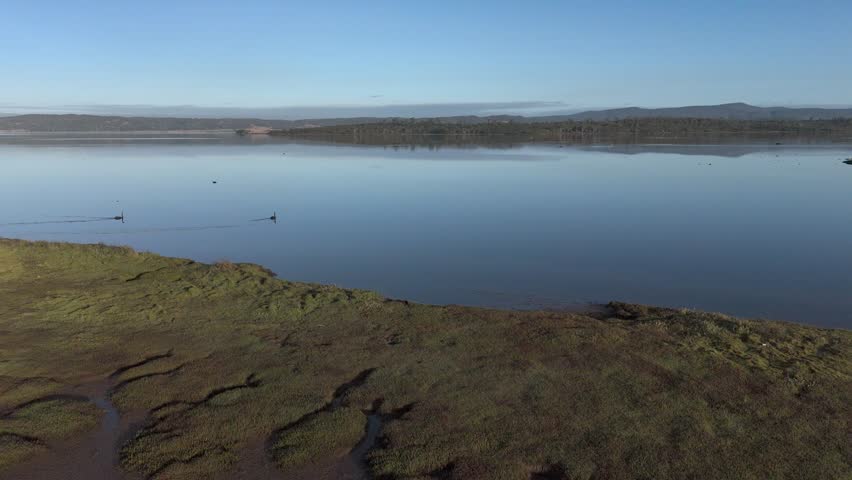 Moulting lagoon in coles bay with mudflats scattered, tasmania, australia, aerial orbital