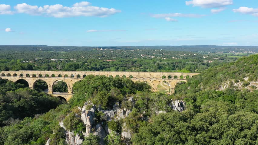 Exploring the majestic Pont du Gard aqueduct in France, discover the stunning architecture of the ancient Pont du Gard aqueduct in southern France. River Gard, Languedoc-Roussillon, France.