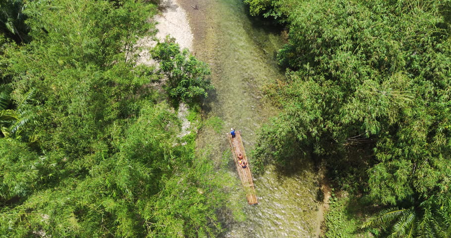 bamboo rafting boat flowing through canal river forest. Travel natural adventures holiday summer. 