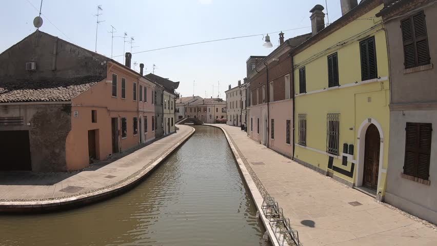 Walking in the centre of Comacchio, picturesque town with canals and bridges in the province of Ferrara, Italy