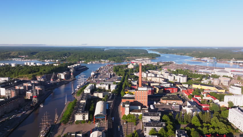 Aerial view of Turku, Finland. Camera is panning over the city center showing the Aura River, ships, buildings and a large smokestack