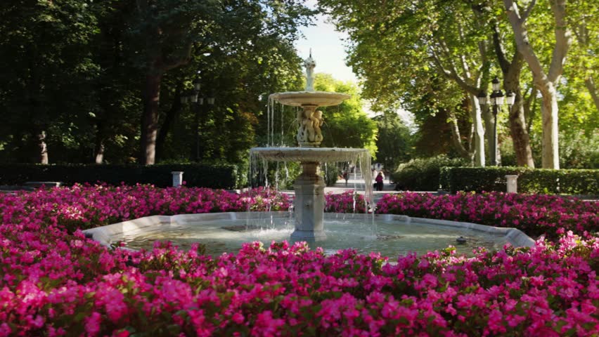 Beautiful fountain with blooming flowers in El Retiro Park, Madrid, sightseeing in Madrid, capital of Spain. High quality 4k footage